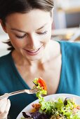 Woman eating salad