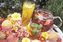 Two different iced teas and strawberry punch in garden