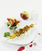 Chicken kebab with rice and tomato & cucumber salad