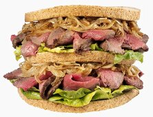 Double-decker roast beef, onion and lettuce sandwich