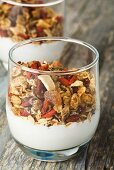 Muesli with dried fruit and yoghurt in a glass