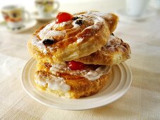 Three raisin danishes on a plate