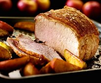 Roast pork with apples, partly carved