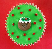 A cupcake with fondant icing and colourful decorations