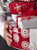 Woman holding a pile of Christmas gifts
