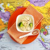 Chicken soup with broccoli on map (Thailand)