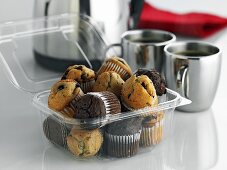 Mini-mufins in plastic container to take away, coffee