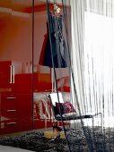 Wardrobe, chair and curtain in bedroom