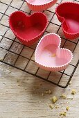 Red and pink, heart-shaped silicone baking moulds