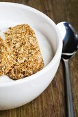 Whole grain wheat biscuits on yoghurt