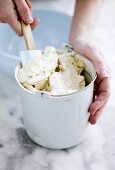 Home-made ice cream in container with spatula