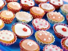 Lots of fairy cakes decorated in pink and white