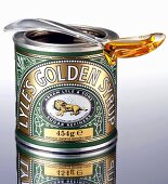Golden syrup in the tin and on a spoon