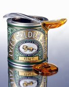 Golden syrup trickling off a spoon