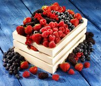 A wooden basket of fresh berries
