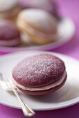 A berry whoopie pie with a dessert fork (close-up)