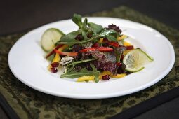 Mixed leaf salad with vegetables and pomegranate seeds