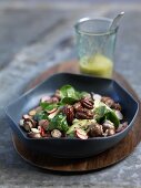 Baby spinach with spicy pecan nuts and a mustard dressing