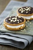 Moon pies (biscuits with a marshmallow filling) with chocolate icing, peanut butter and nuts