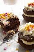 Chocolate whoopie pies with cream and sugar stars, one with a bite taken out