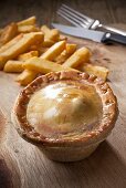 Steak and kidney pie with French fries (England)