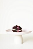 Chocolate Whoopie pie, wrapped with string, on a cake stand