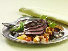 Roasted ostrich steaks with root vegetables