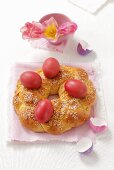 A sweet bread wreath with Easter eggs and sugar sprinkles