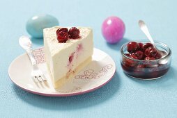 A slice of creamy cheesecake with sour cherries