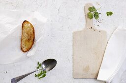 Toasted bread, a spoon and a chopping board