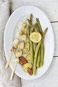 Monk fish kebabs with green asparagus and fried potatoes