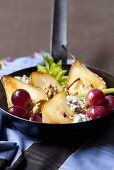 Fried pears with grapes, nuts and blue cheese