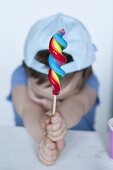 Young boy with a spiral shaped lollipop