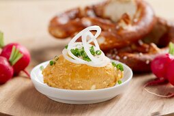 Bavarian snack: Obatzda with radishes and pretzel