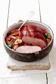 Ham braised in wine with figs and cranberries