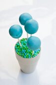 Blue cake pops in a cup of sugar beads