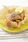 Salmon in parchment paper with potatoes and tomatoes