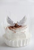 A chocolate cream tartlet decorated with two doves