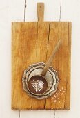 Sea salt on a wooden spoon on chopping board