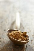 Natural brown sugar on a wooden spoon