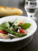 Asparagus salad with rocket, tomatoes and parmesan