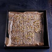 Home made whole grain crackers with seeds on a baking sheet