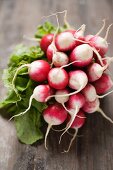 A bunch of radishes on a wooden surface