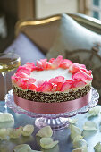 A wedding cake with rose petals