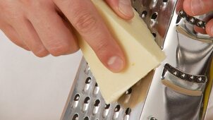 Parmesan being grated (close-up)
