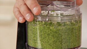 Pesto ingredients being mixed together