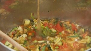 Vegetable stew being quenched with stock