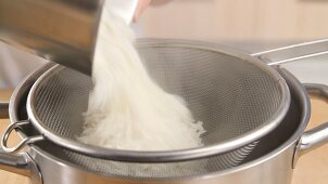 Rice being poured into a pot