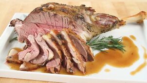Roasted leg of lamb in slices and on the bone