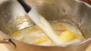Cream being folded into egg yolk